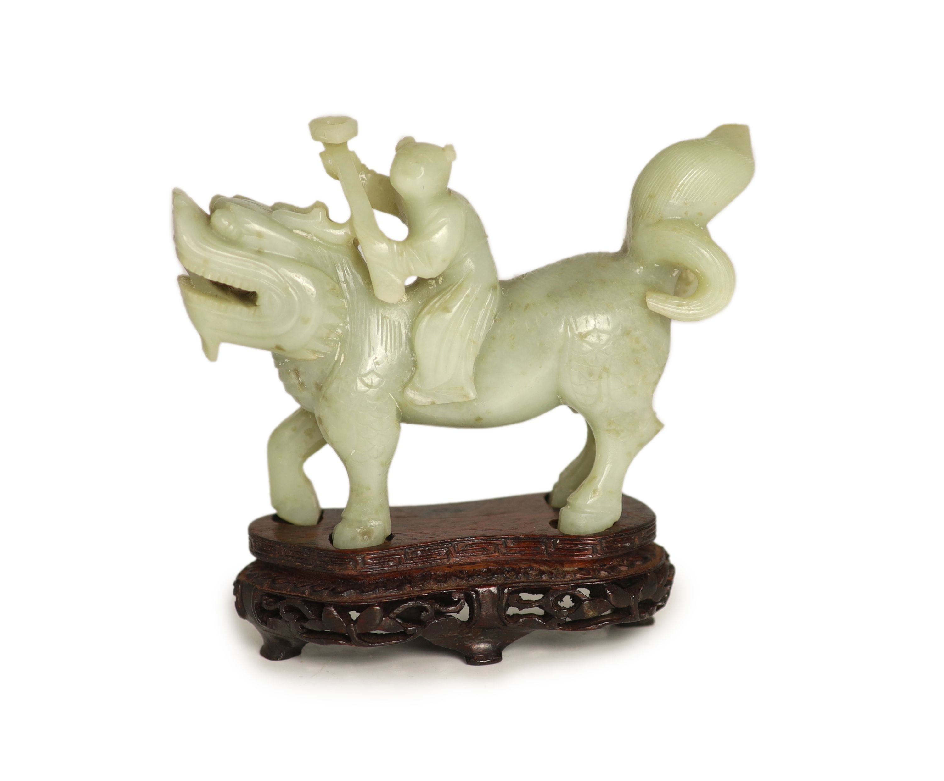 A Chinese pale celadon-grey jade group of a boy riding a qilin, 17th/18th century, 13.5cm long, wood stand